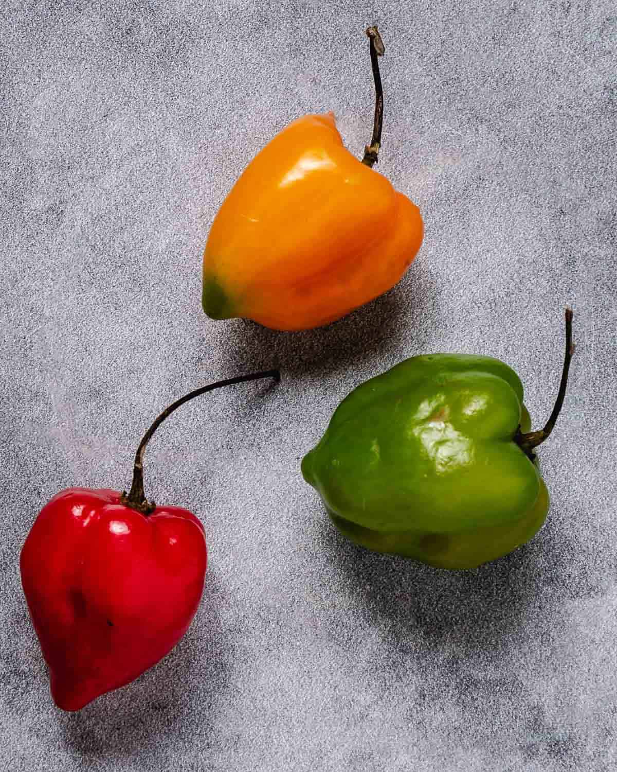 Red, yellow, and green spicy habanero peppers.
