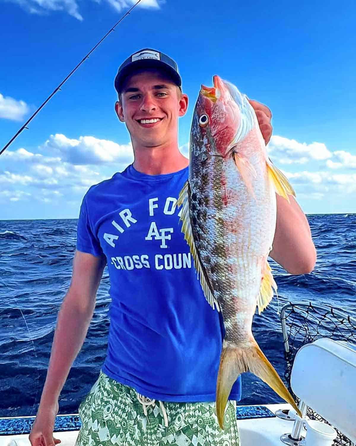 man holding yellowtail snapper fish in Key Largo, Florida.