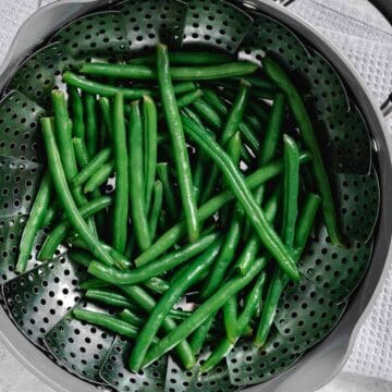 steaming green beans in a pot.