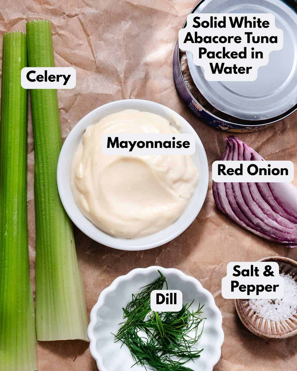 Ingredients for deli tuna salad: solid white albacore tuna, mayonnaise, celery, red onion, dill, salt and pepper.