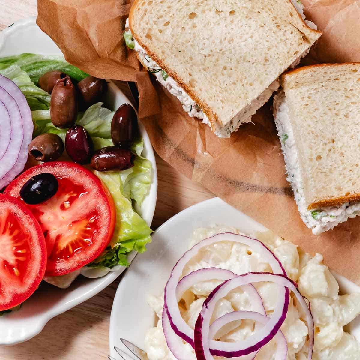deli tuna sandwich with coffee and lettuce and tomato salad