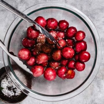 Mix little red potatoes with seasonings in a bowl.