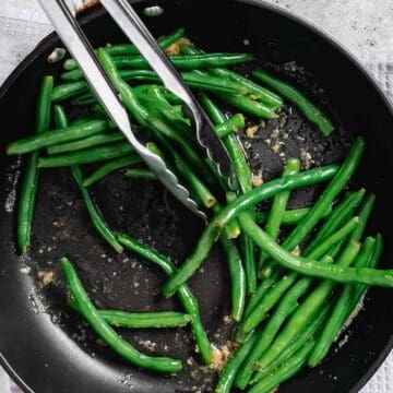 sautéing green beans with garlic.