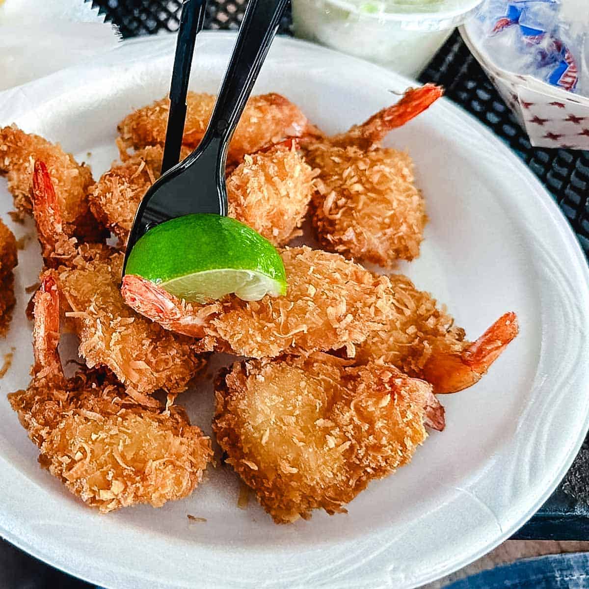 alabama jacks coconut shrimp with lime wedge.