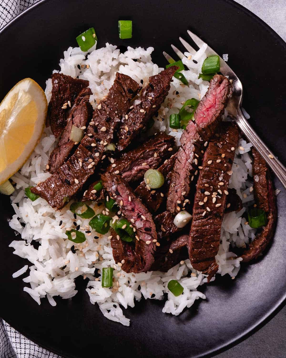 cooked skirt steak with rice and sesame seeds