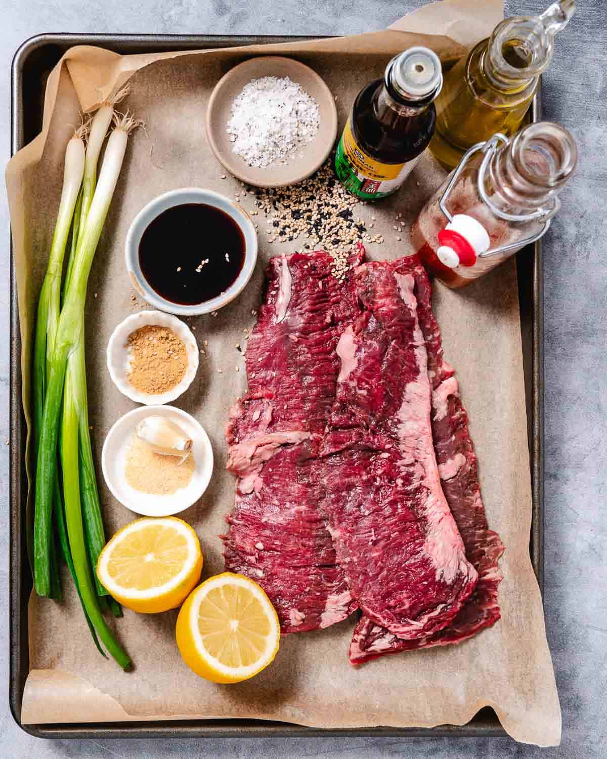What you need: skirt steak, green onions, garlic, ginger, soy sauce, lemon, salt and pepper, sesame oil, olive oil, apple cider vinegar.