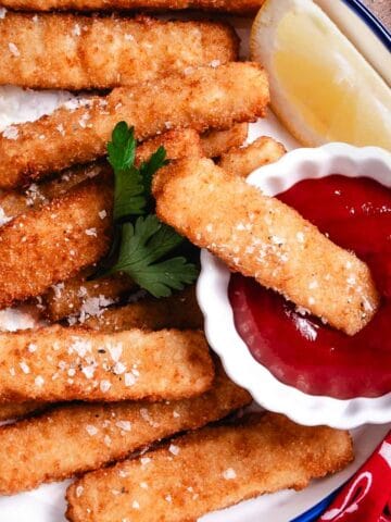 bowl of fish sticks with ketchup