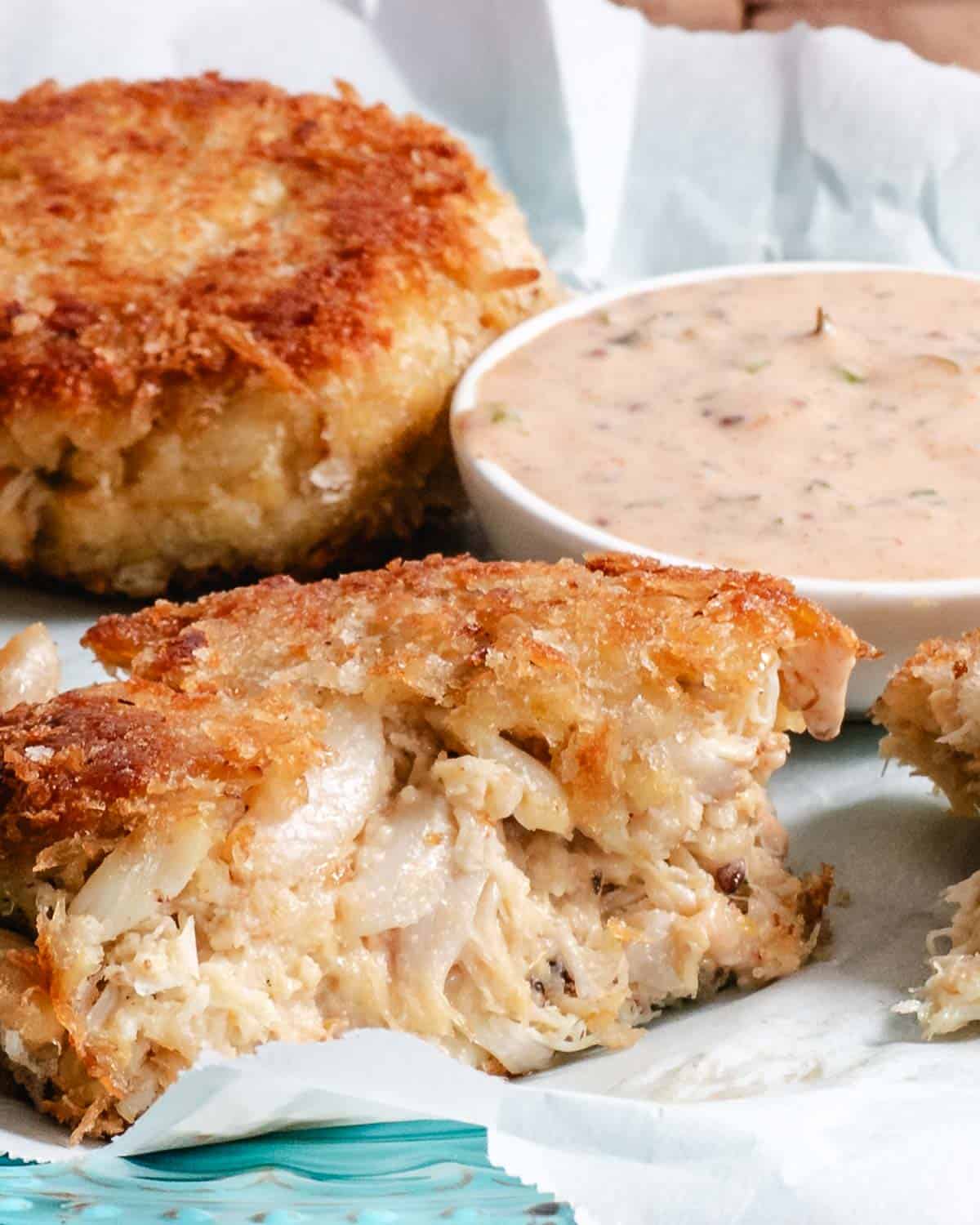 Cut-open lump and claw crab cake with a crisp panko crust and remoulade sauce.