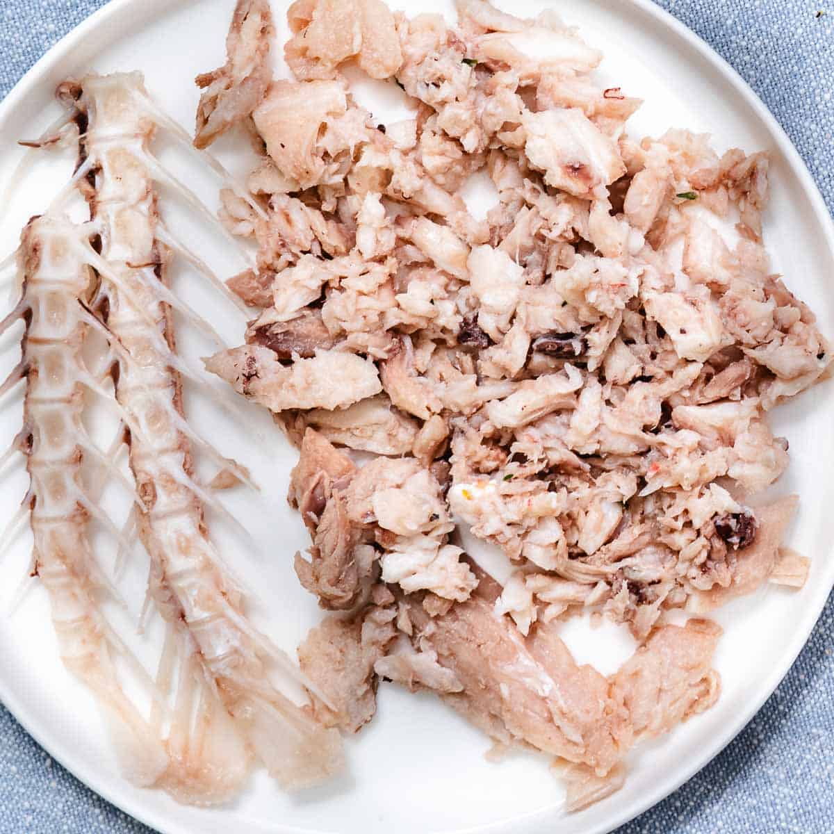 Cooked red snapper bones and picked fish meat after making homemade fish stock.