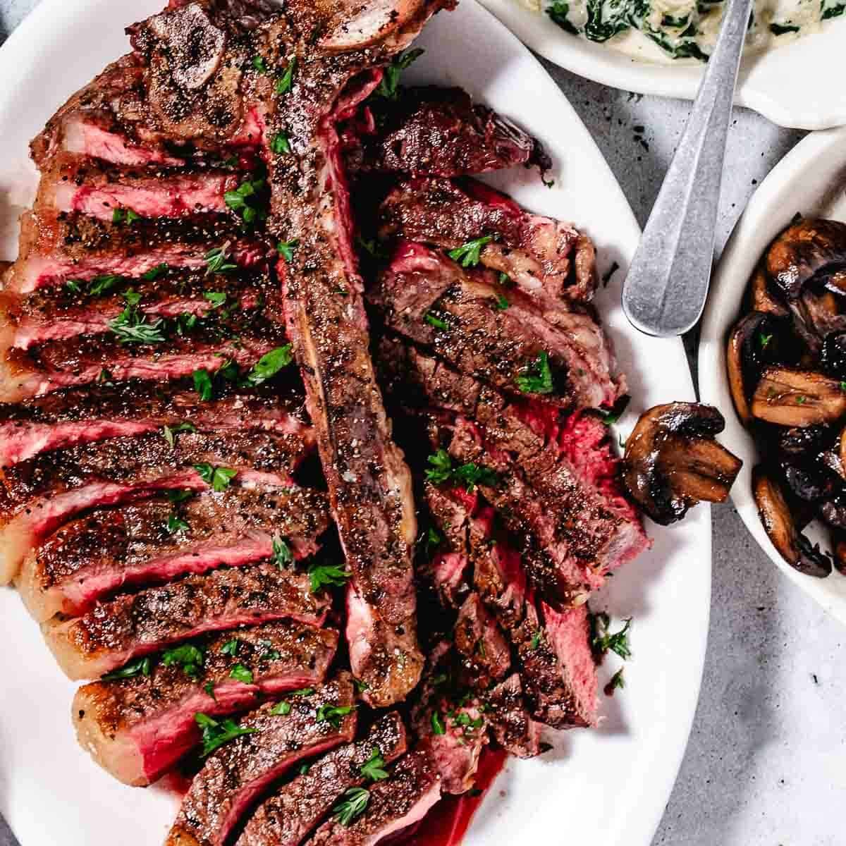 overhead view of cooked medium rare porterhouse steak