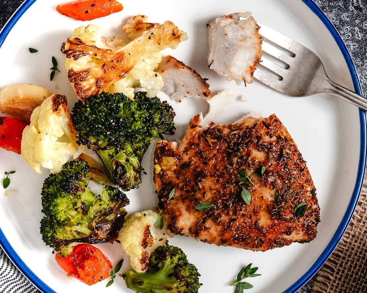 Tripletail fish with Cajun seasoning and mixed vegetables.