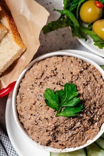 bowl of chopped liver with bread and crackers