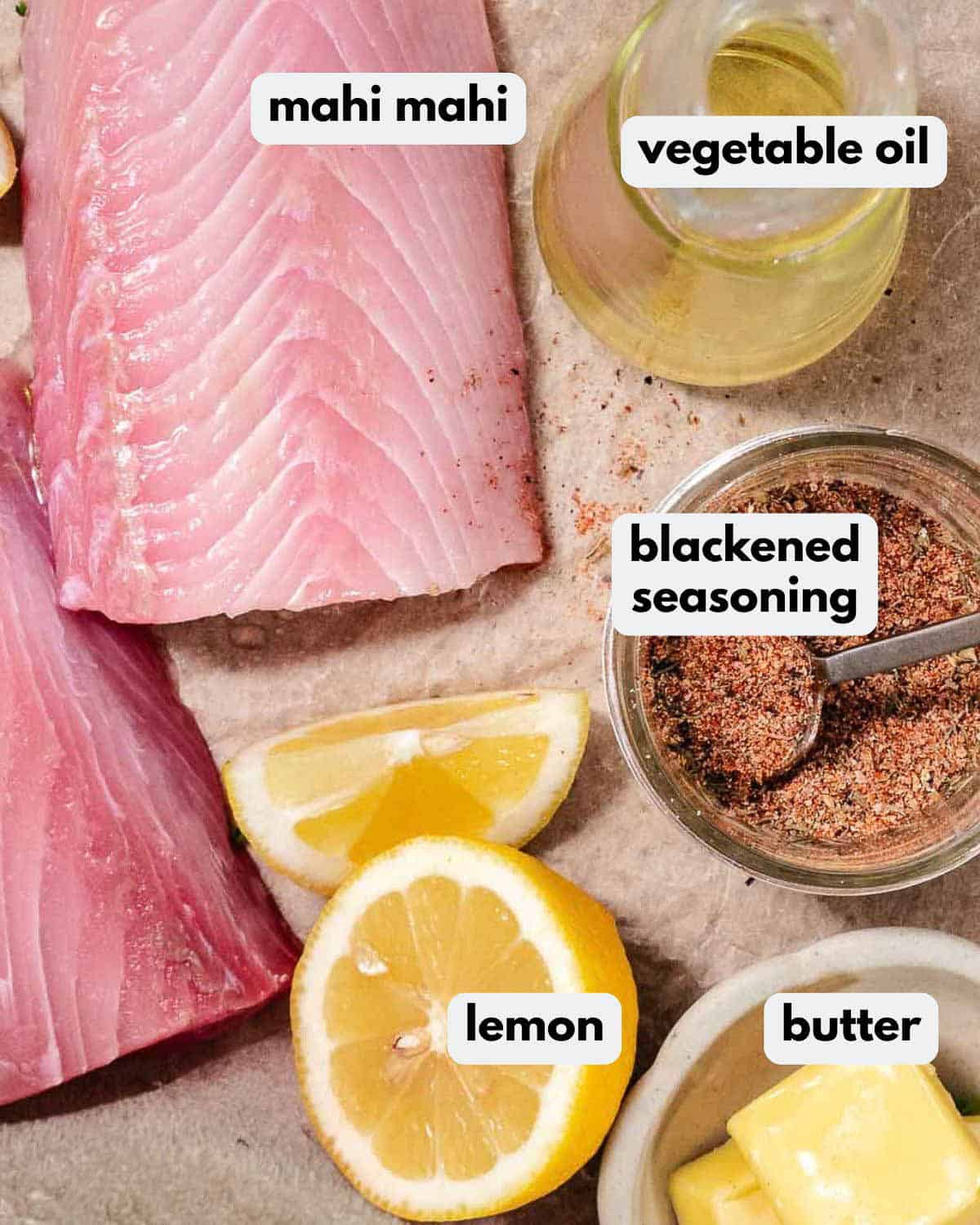 Fresh mahi mahi fillets with blackened seasoning, butter, oil, lemon, salt, and pepper.