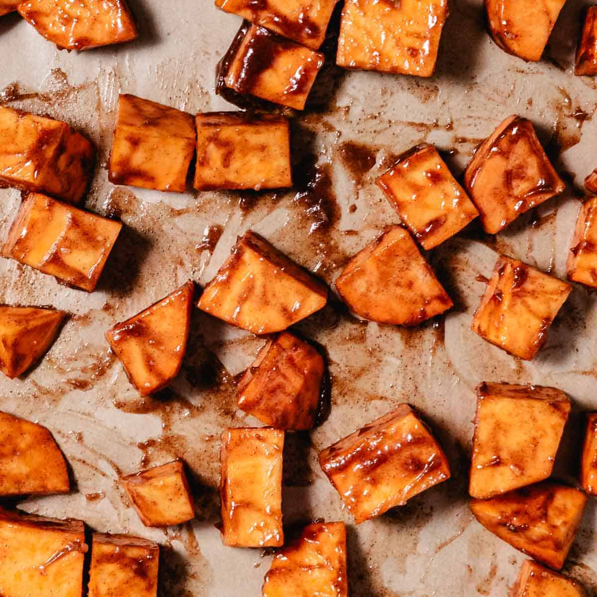 cinnamon sugar sweet potato cubes on sheet pan.
