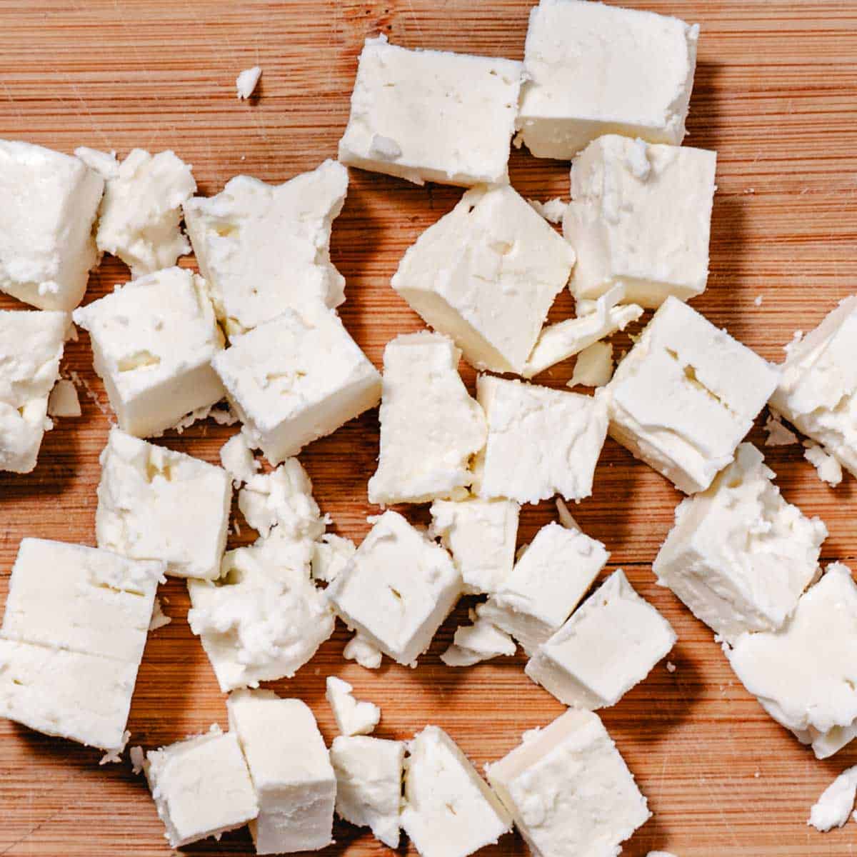 Diced feta cheese on a cutting board