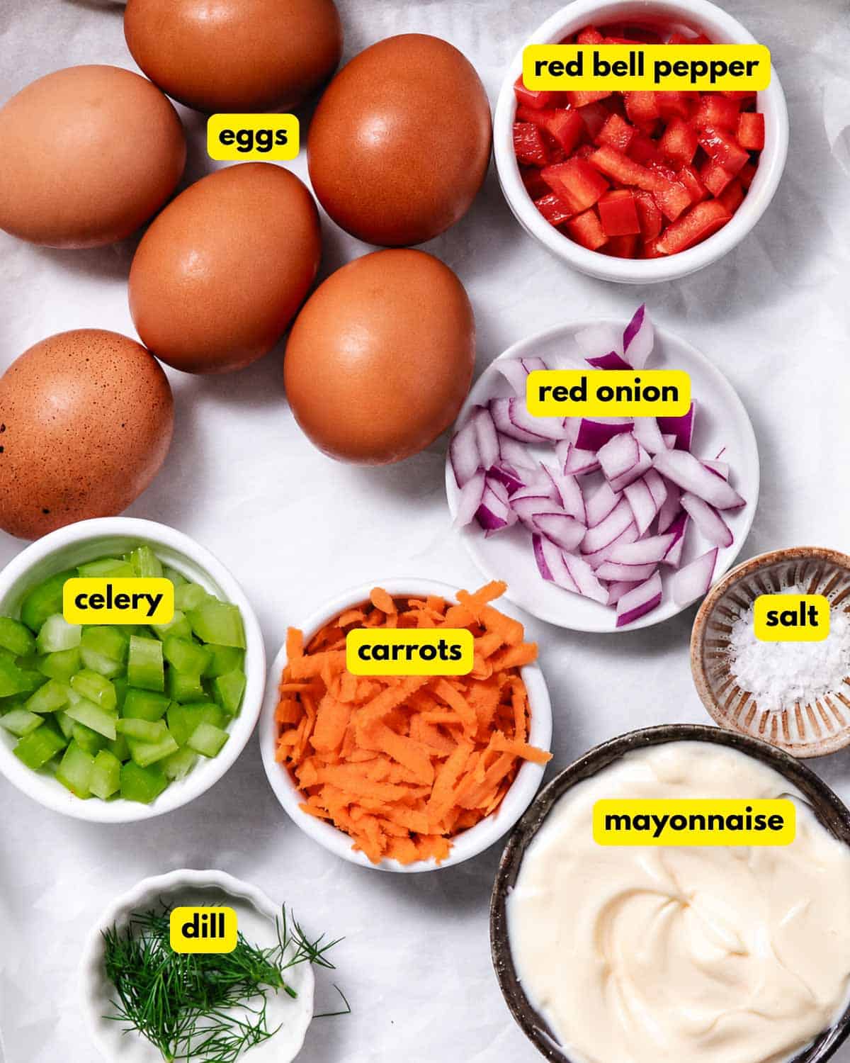Ingredients for veggie egg salad: eggs, red bell pepper, red onion, celery, carrots, dill, salt, and mayonnaise.