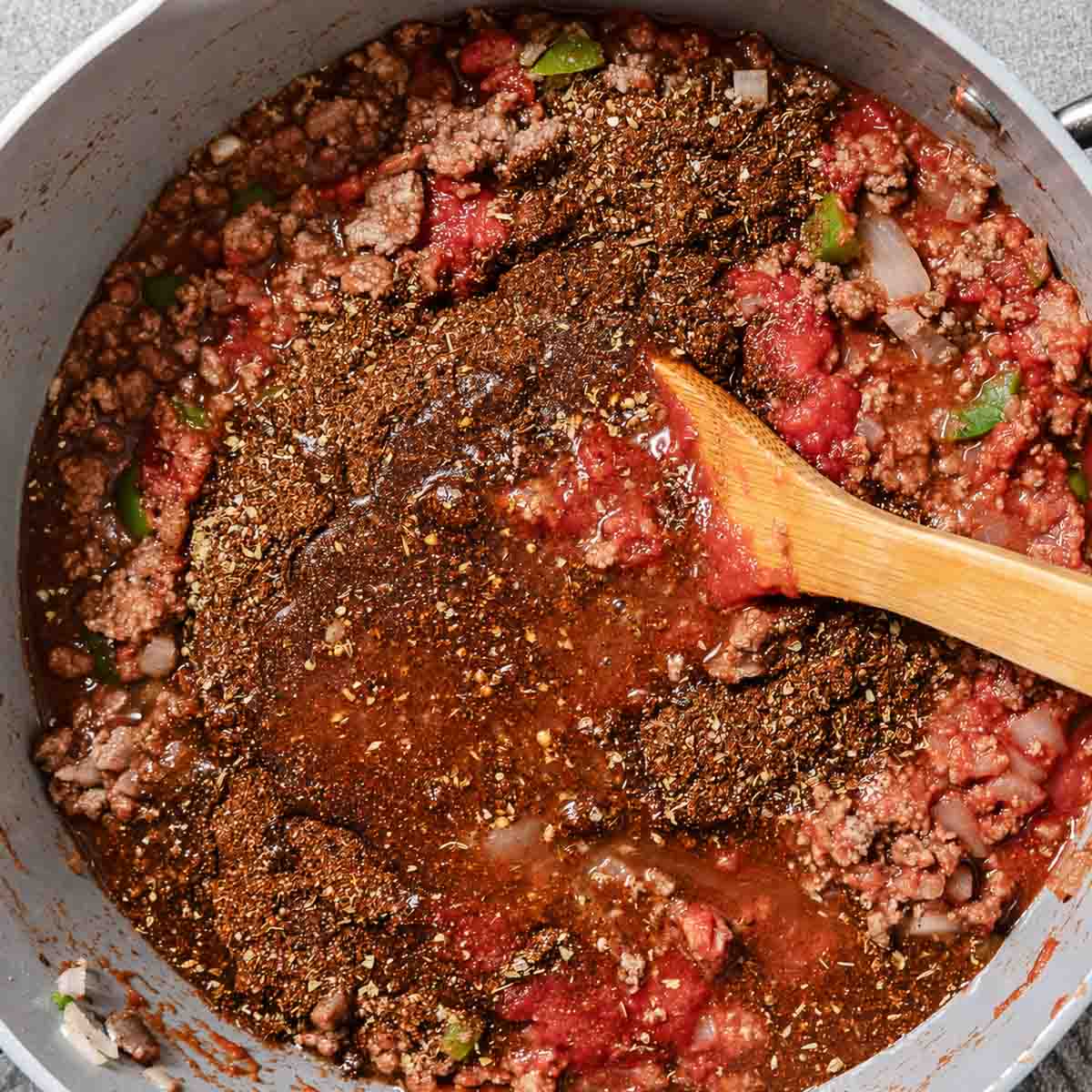 Tomatoes and chili seasonings added to the ground chuck and vegetables.