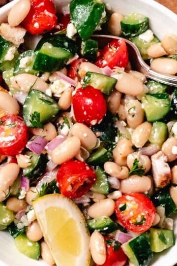 white bean cucumber tomato salad with vinaigrette and a side of pita chips