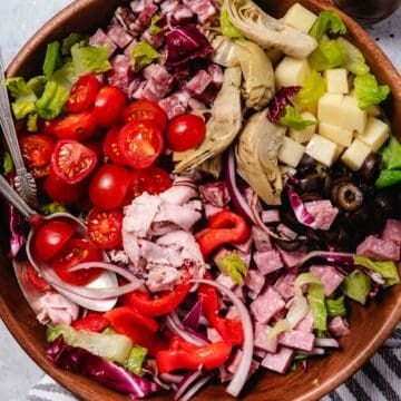chopped antipasto salad in wooden salad bowl