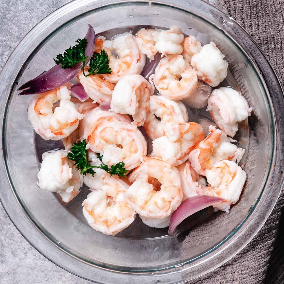 chilling shrimp after boiling in a bowl of ice water