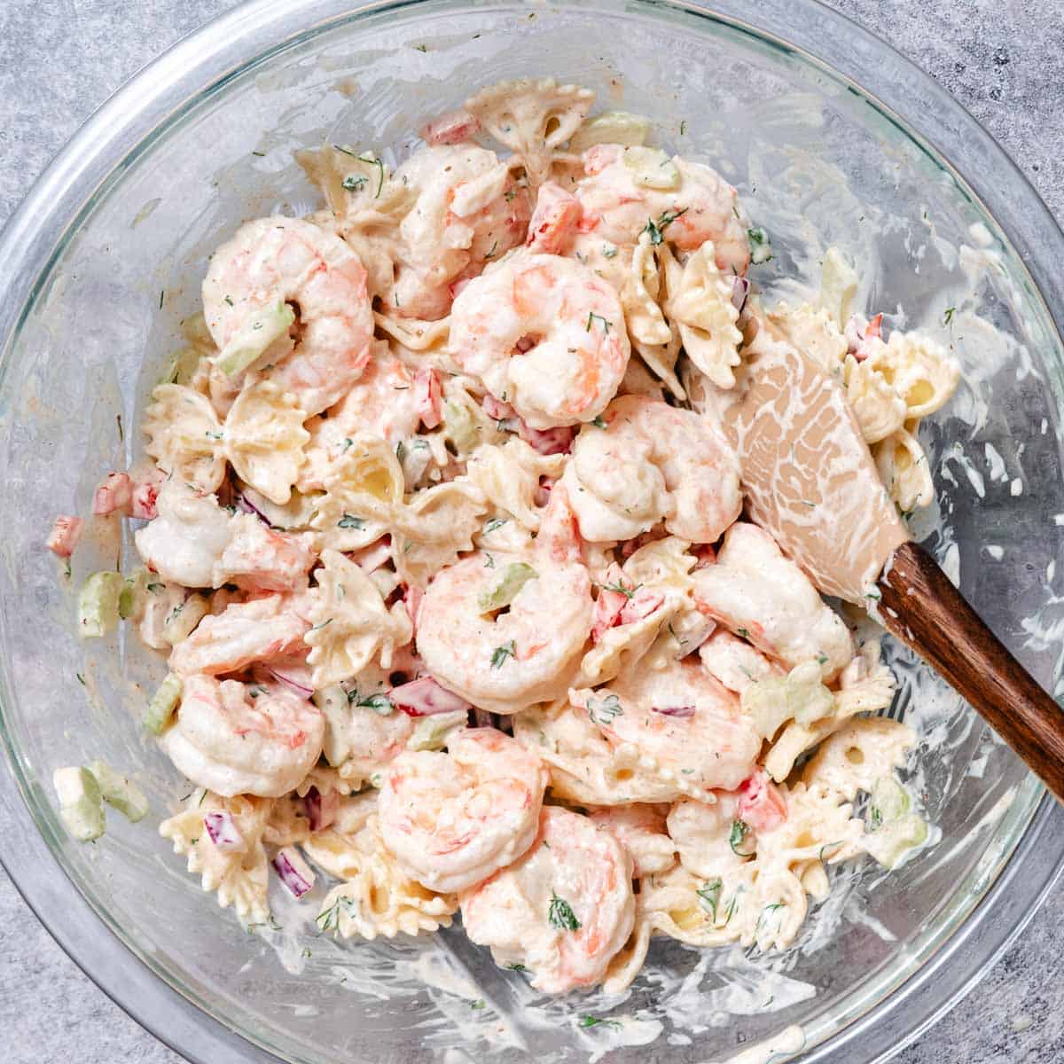 shrimp and pasta salad in mixing bowl.