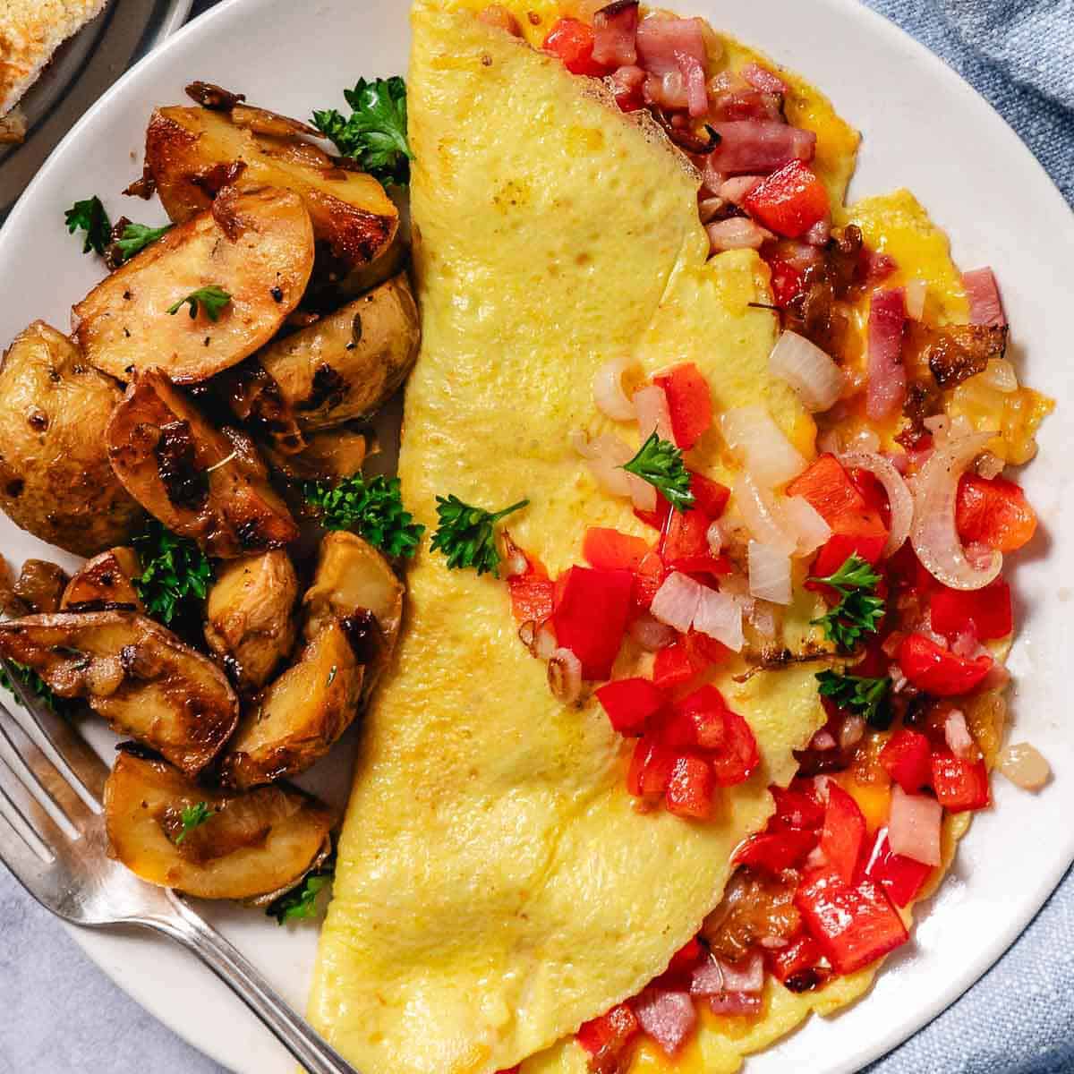 Top view of a classic Denver omelet with diced ham, peppers, onions, and cheddar.
