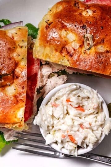 tuna sandwich with coleslaw and a pickle