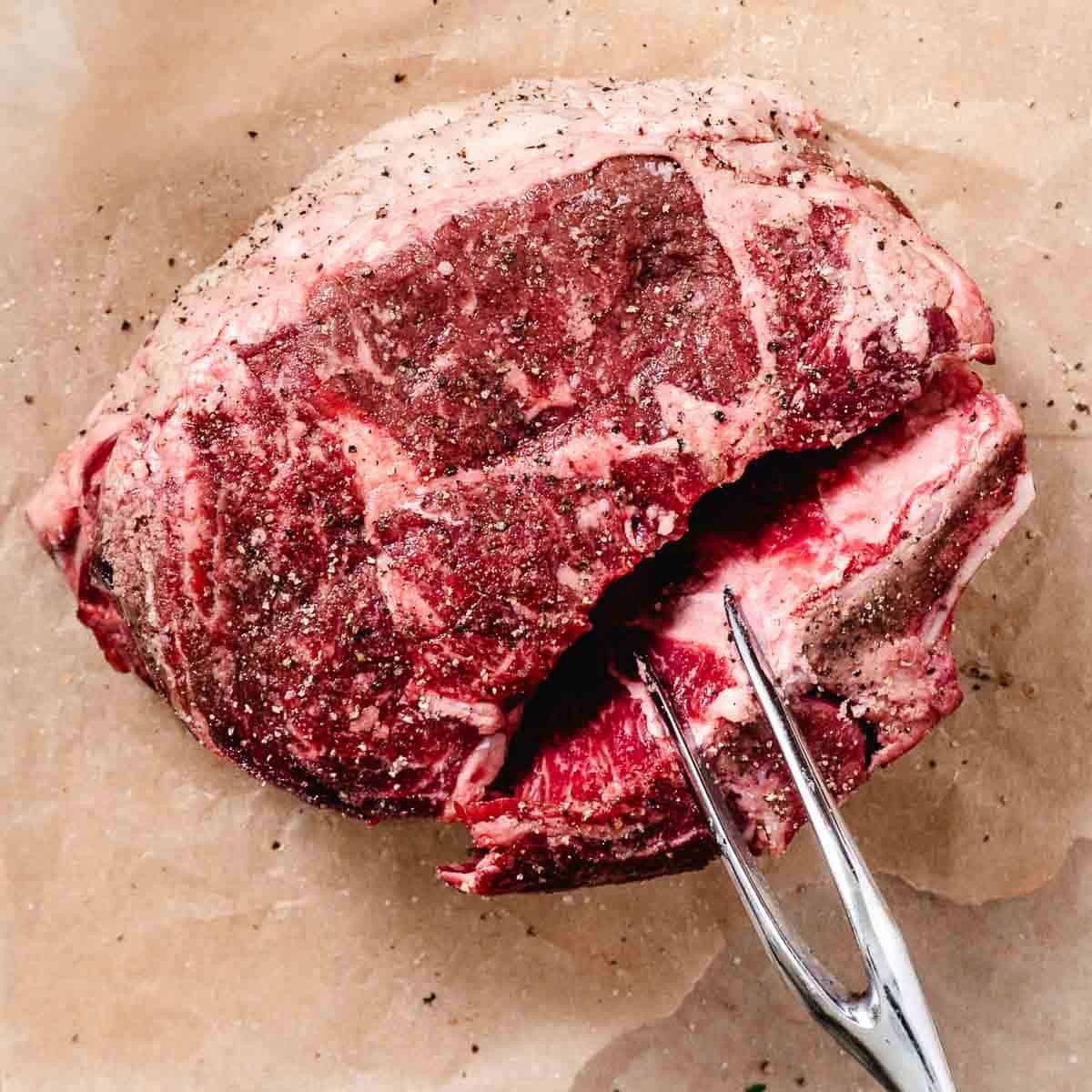 standing rib roast with rib bones tied onto the meat for easy removal.