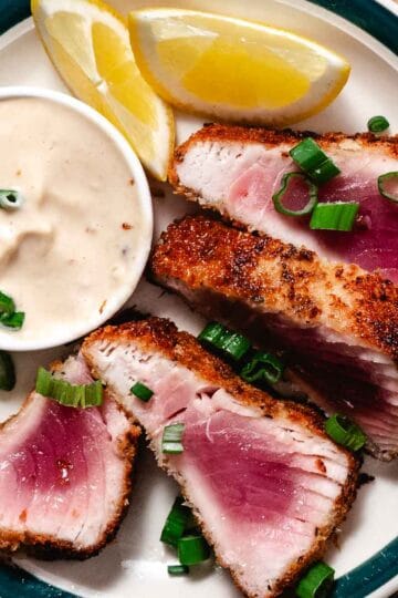 Panko crusted tuna steak sliced with rare pink center, served with creamy dipping sauce and lemon wedges.