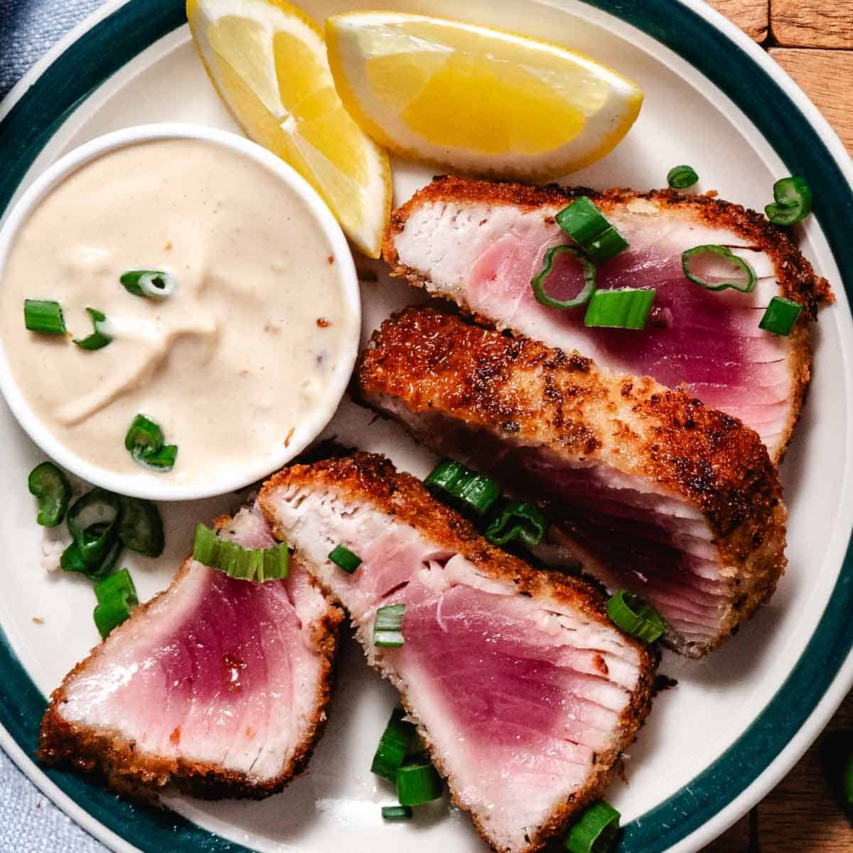 Panko crusted tuna steak sliced with rare pink center, served with creamy dipping sauce and lemon wedges.