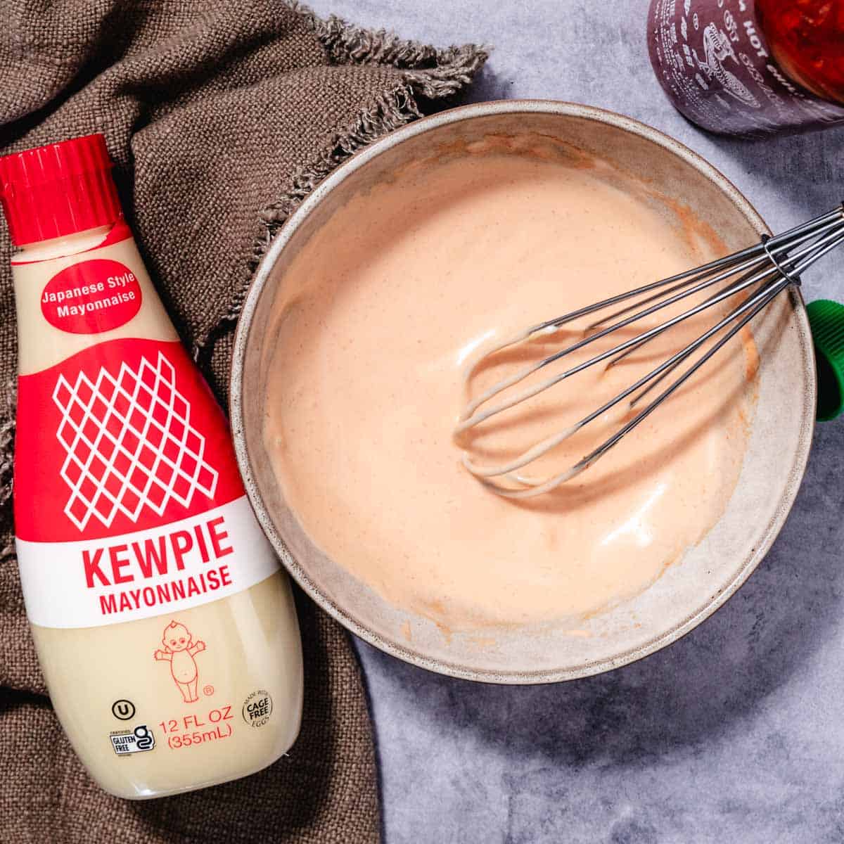 Whisking spicy mayo with Kewpie mayonnaise in a bowl for sushi sauce