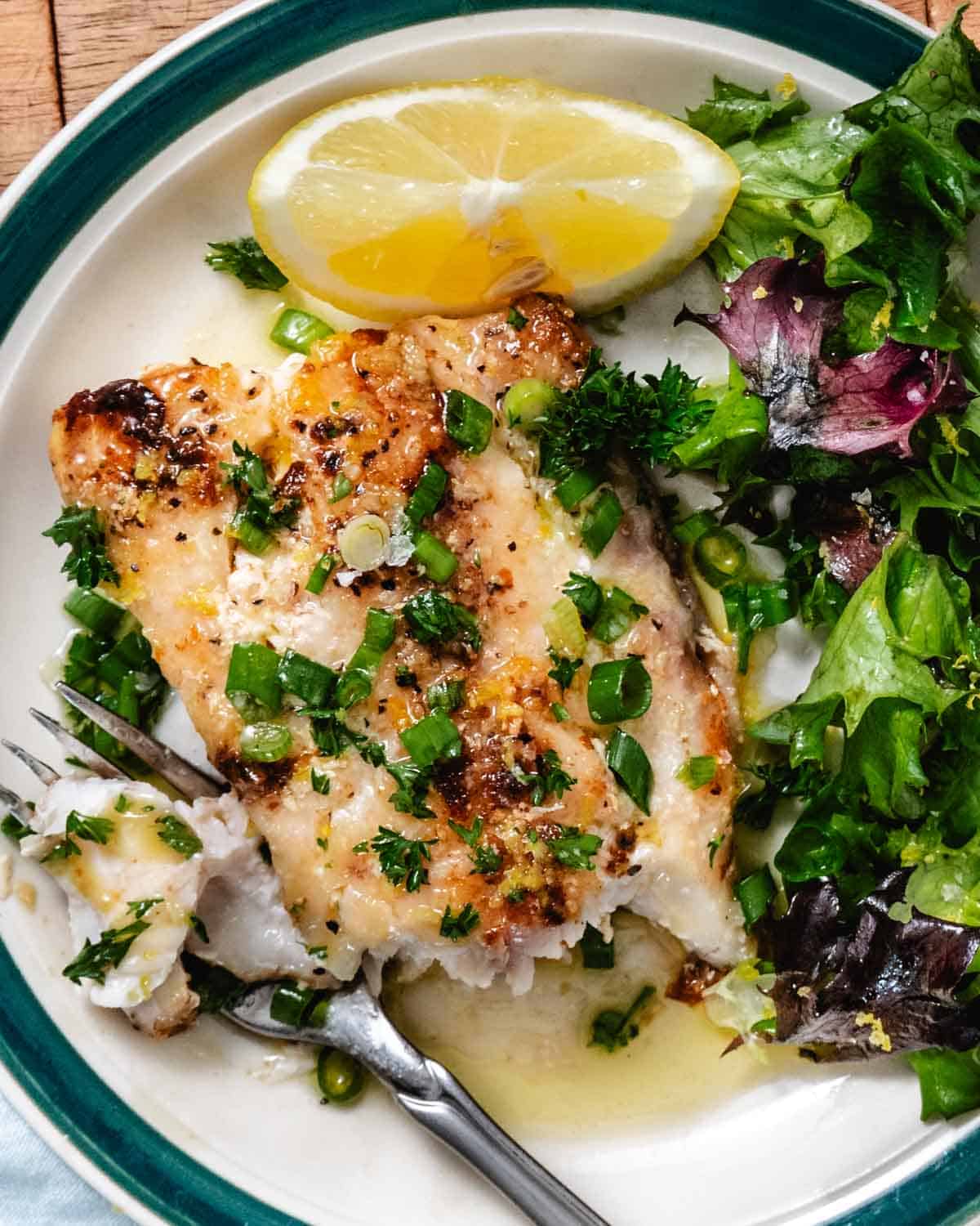 Pan seared tilefish with lemon butter, chopped green onions, and a simple green salad.