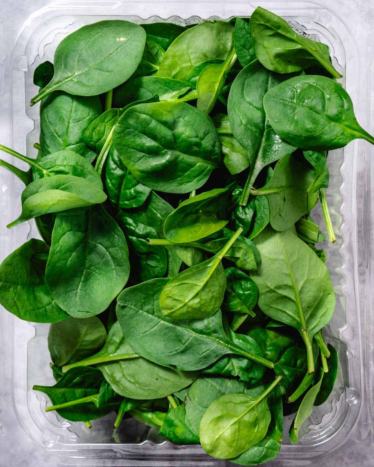 box of raw baby spinach