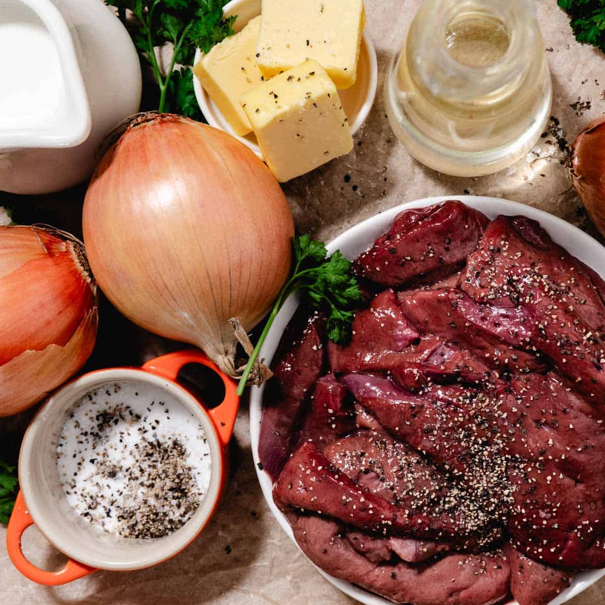 Raw beef liver with onions, butter, salt, pepper, and oil for baked beef liver and onions
