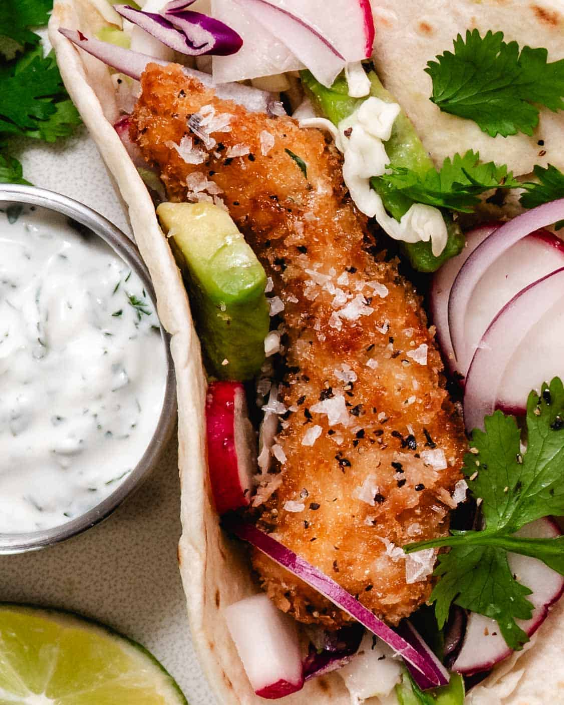crispy chicken tacos with avocado, onions and cilantro lime dip