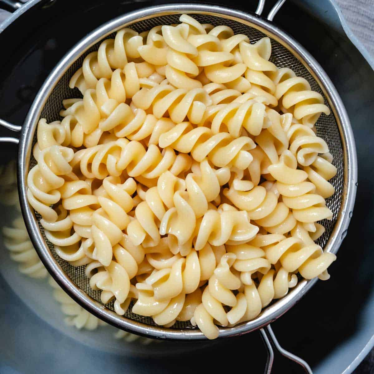 fusilli pasta in a strainer.