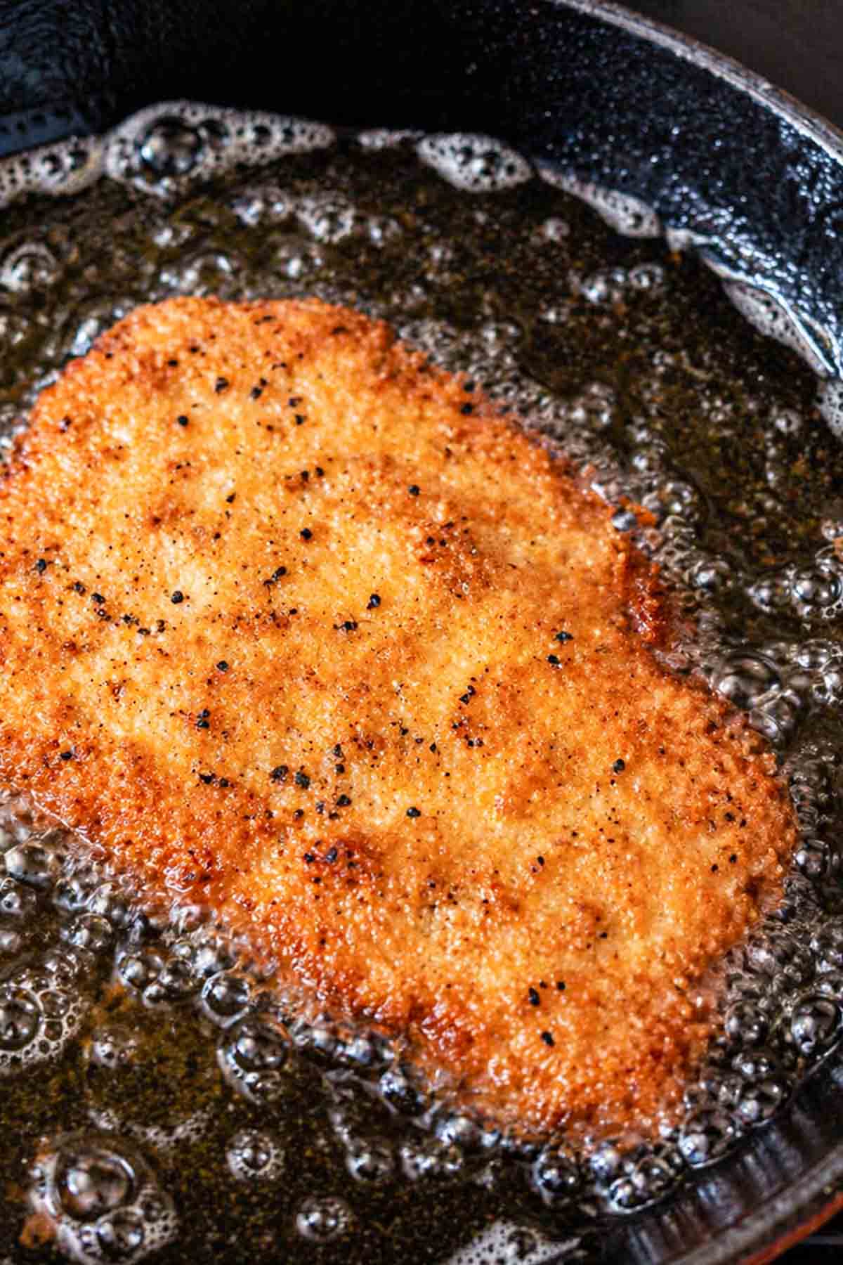 frying chicken cutlet in cast iron skillet