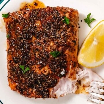 Flaky blackened mahi mahi with a fork showing the moist interior of the fish.