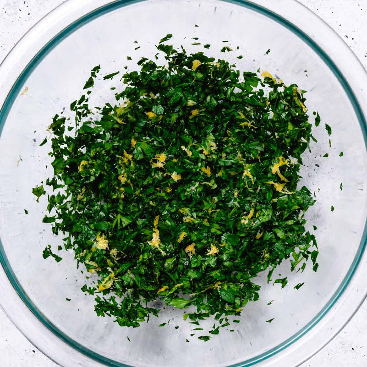 mixing gremolata in a mixing bowl
