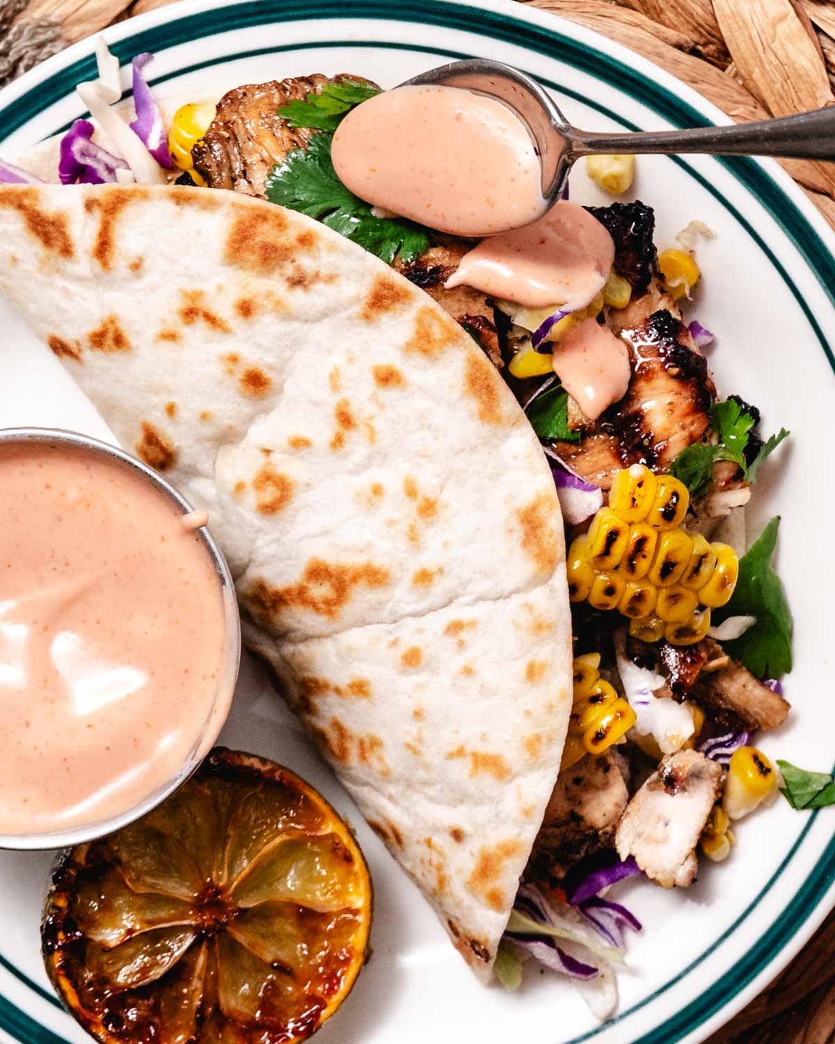 mojo chicken tacos with corn, cabbage, and taco sauce