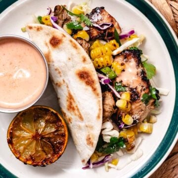 mojo chicken tacos with grilled corn, cabbage slaw, and taco sauce