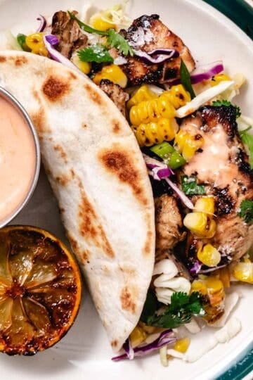 mojo chicken tacos with grilled corn, cabbage slaw, and taco sauce