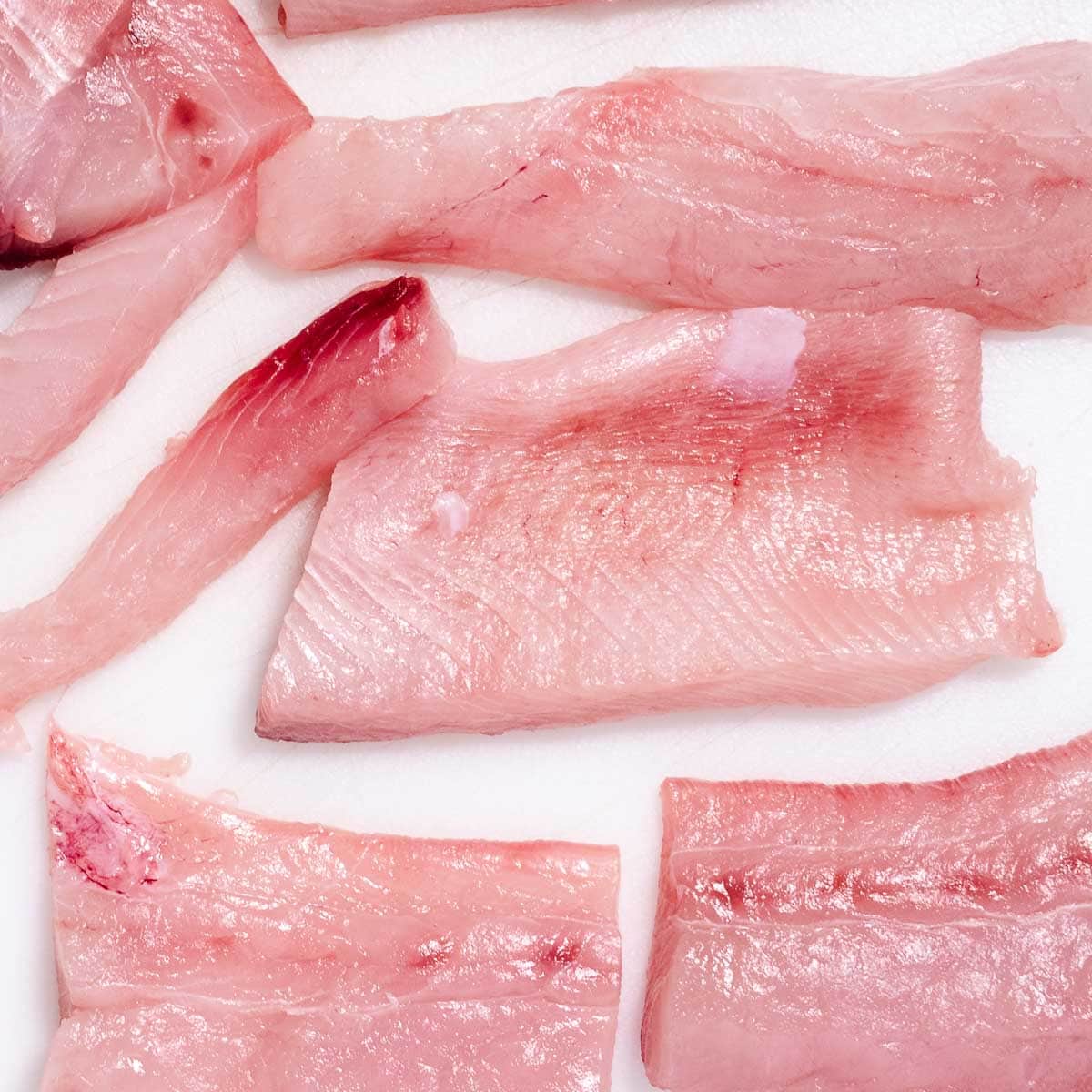 Raw mahi mahi fillets, patted dry and ready to season.
