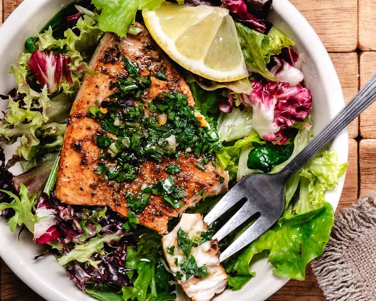 seared swordfish over mixed green salad topped with chimichurri sauce.