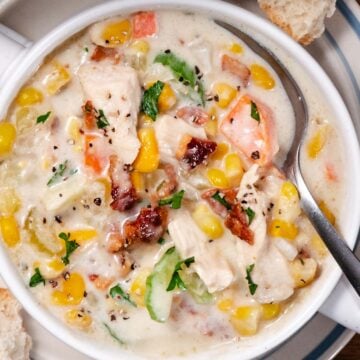 Corn and Chicken Chowder with bacon and potatoes in a crock.