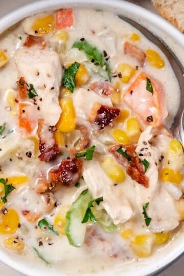 Corn and Chicken Chowder with bacon and potatoes in a crock.