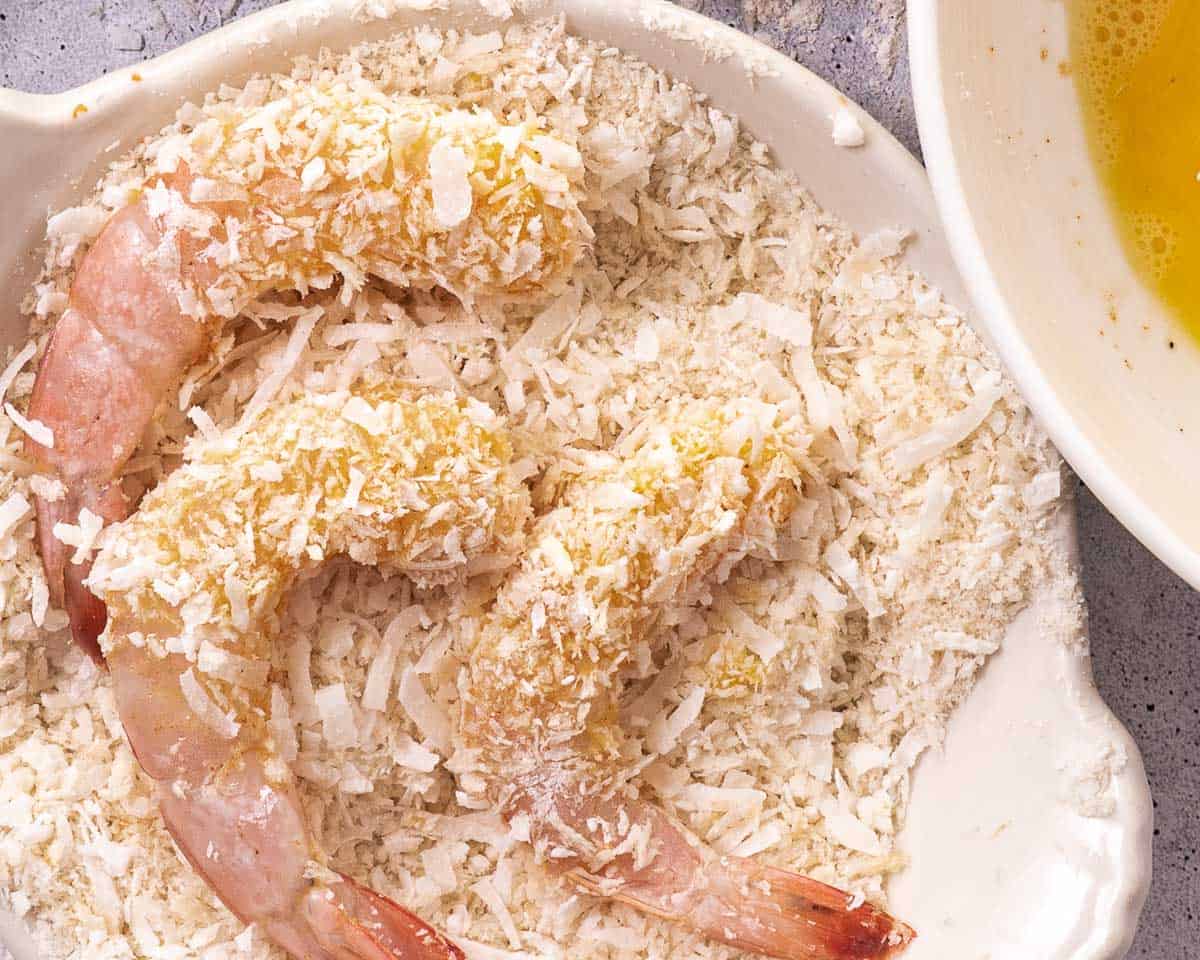 Shrimp coated in egg wash and pressed into coconut flakes before frying.