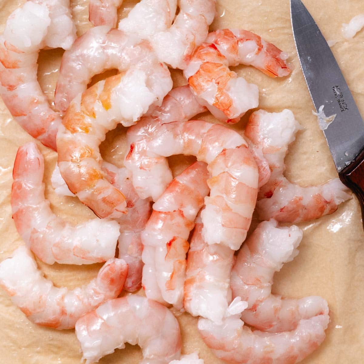 peeled and deveined pink shrimp with paring knife