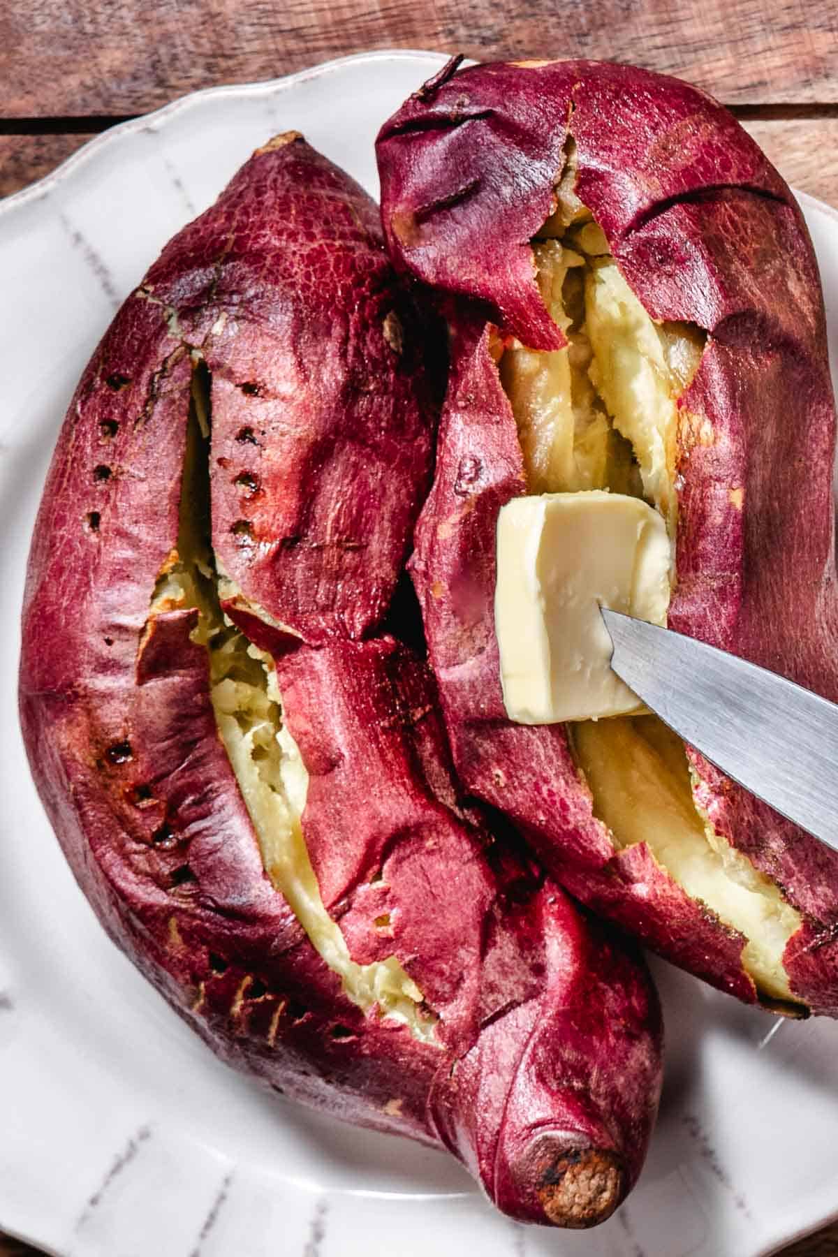 Adding butter to a baked Japanese sweet potato