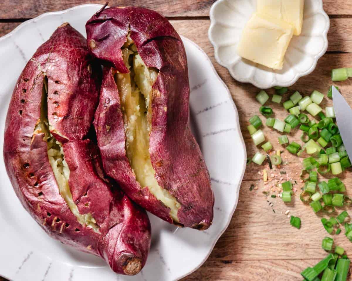 Baked Japanese sweet potatoes with butter and sliced scallions
